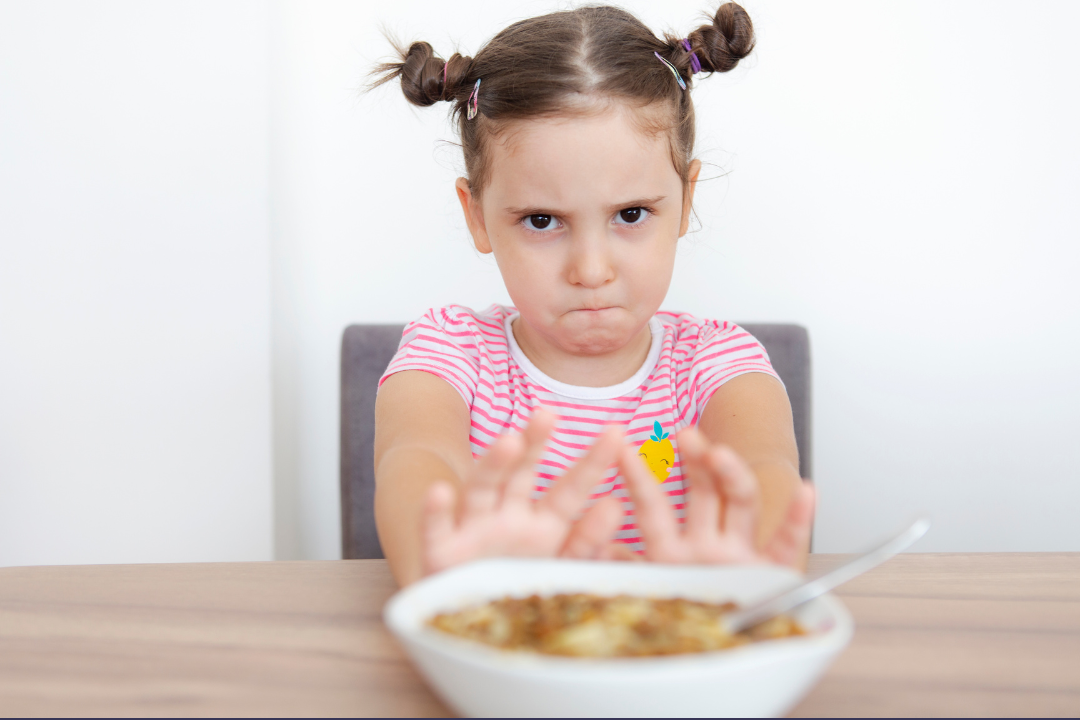 Child pushing away a bowl of food